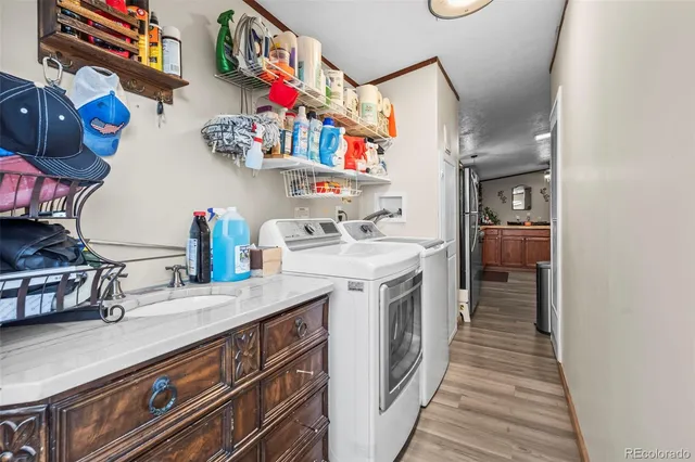 a kitchen that has a lot of cabinets and wooden floor