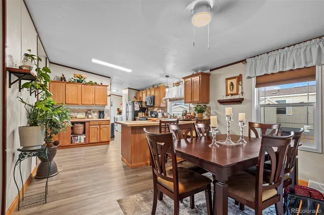 a view of a dining room with furniture and wooden floor