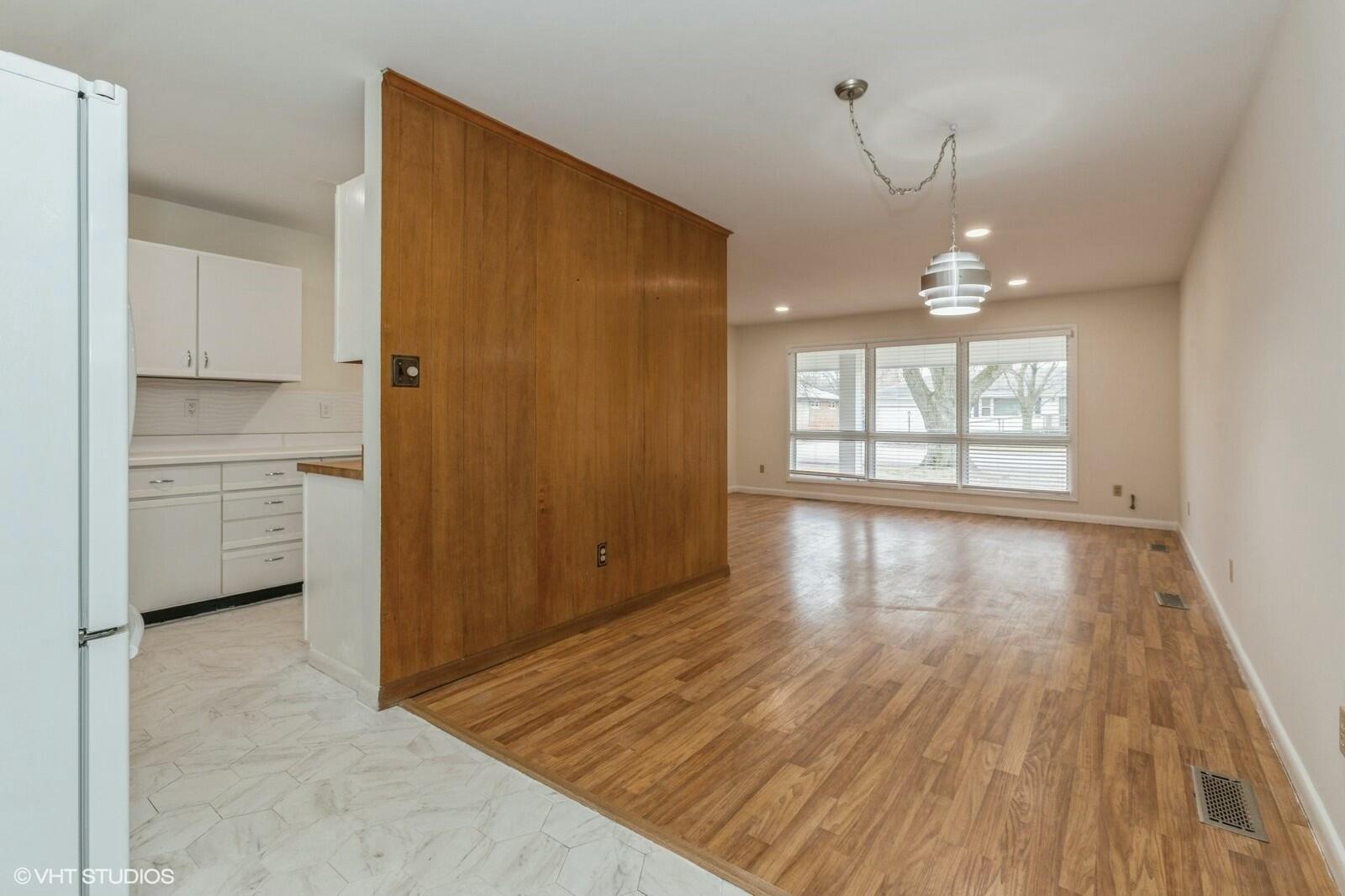 121 Belmont Court Michigan City, IN 46360 - Photo 4 of 12 wooden floor in an empty room with a window