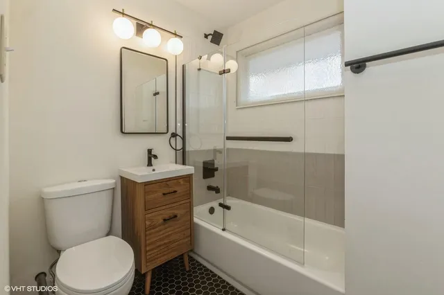 a bathroom with a toilet sink and shower