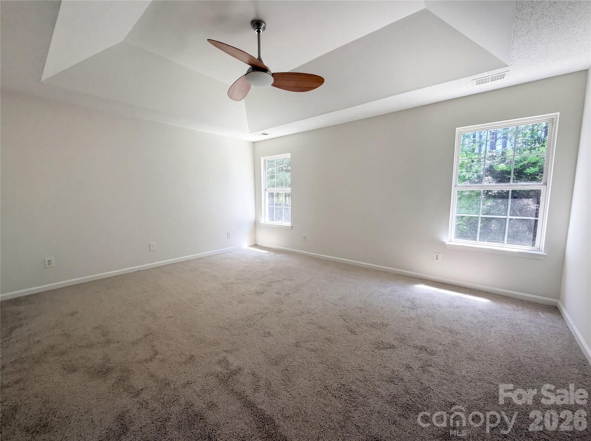 7423 Henderson Park Road Huntersville, NC 28078 - Photo 4 of 16 an empty room with windows and fan