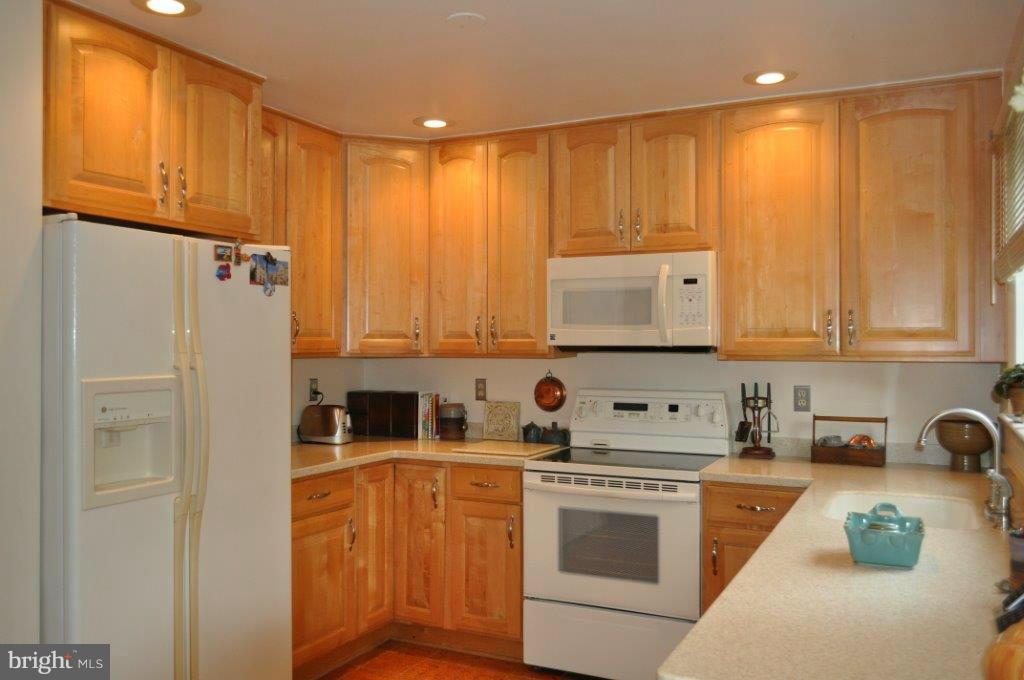 5565 Suffield Court Columbia, MD 21044 - Photo 2 of 30 a kitchen with stainless steel appliances granite countertop a refrigerator sink and cabinets