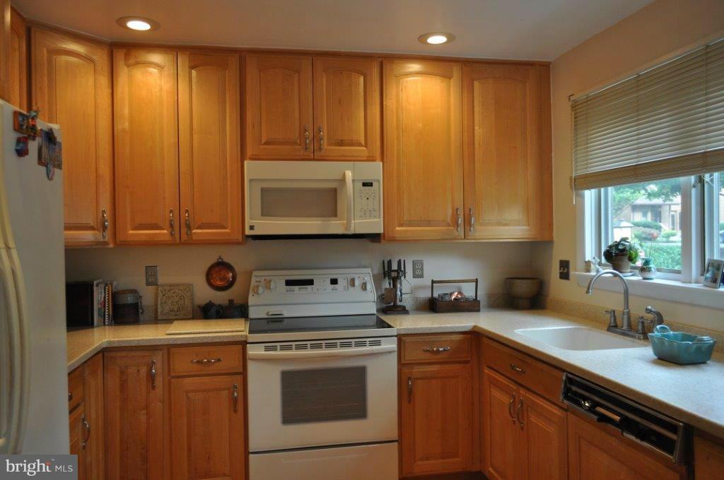 5565 Suffield Court Columbia, MD 21044 - Photo 6 of 30 a kitchen with stainless steel appliances white cabinets and a stove top oven
