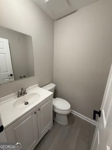 a bathroom with a sink mirror vanity and toilet