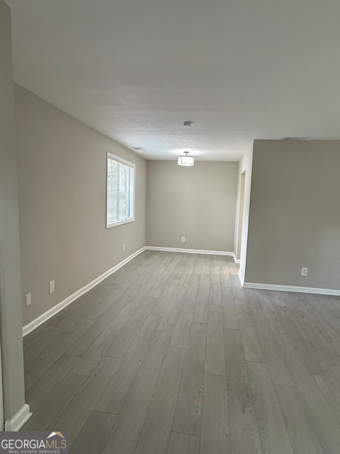33 Twiggs Corners Peachtree City, GA 30269 - Photo 2 of 32 a view of an empty room with wooden floor and a window