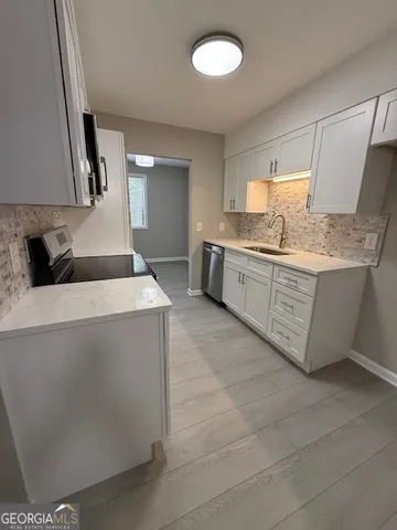 a kitchen with stainless steel appliances granite countertop a sink and a stove