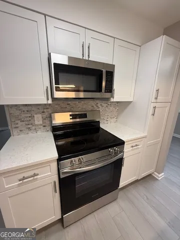 a kitchen with a stove and a microwave