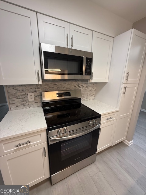 33 Twiggs Corners Peachtree City, GA 30269 - Photo 9 of 32 a kitchen with a stove and a microwave