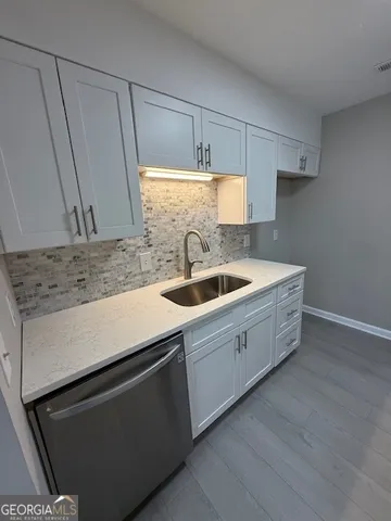 a kitchen with a sink and cabinets