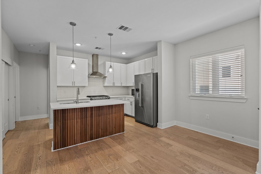 2827 Manor Road, Unit 2201 Austin, TX 78722 - Photo 9 of 40 Open concept living space featuring wood-finish flooring