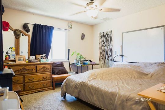 315 Henry Street Ridgecrest, CA 93555 - Photo 23 of 27 a bedroom with a bed and a mirror on the dresser