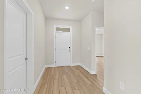 a kitchen with white cabinets and sink