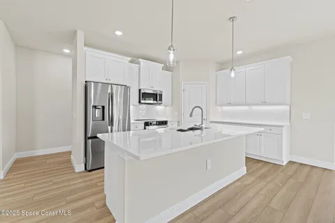 a view of kitchen with furniture and wooden floor