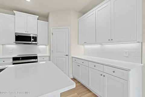 a kitchen with stainless steel appliances a stove microwave and refrigerator