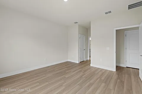 a view of small space with wooden floor and a window