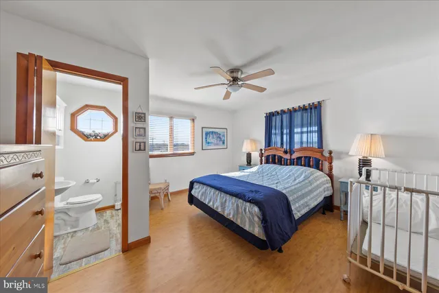a spacious bedroom with a bed and a chandelier