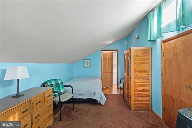 a bedroom with furniture and a lamp