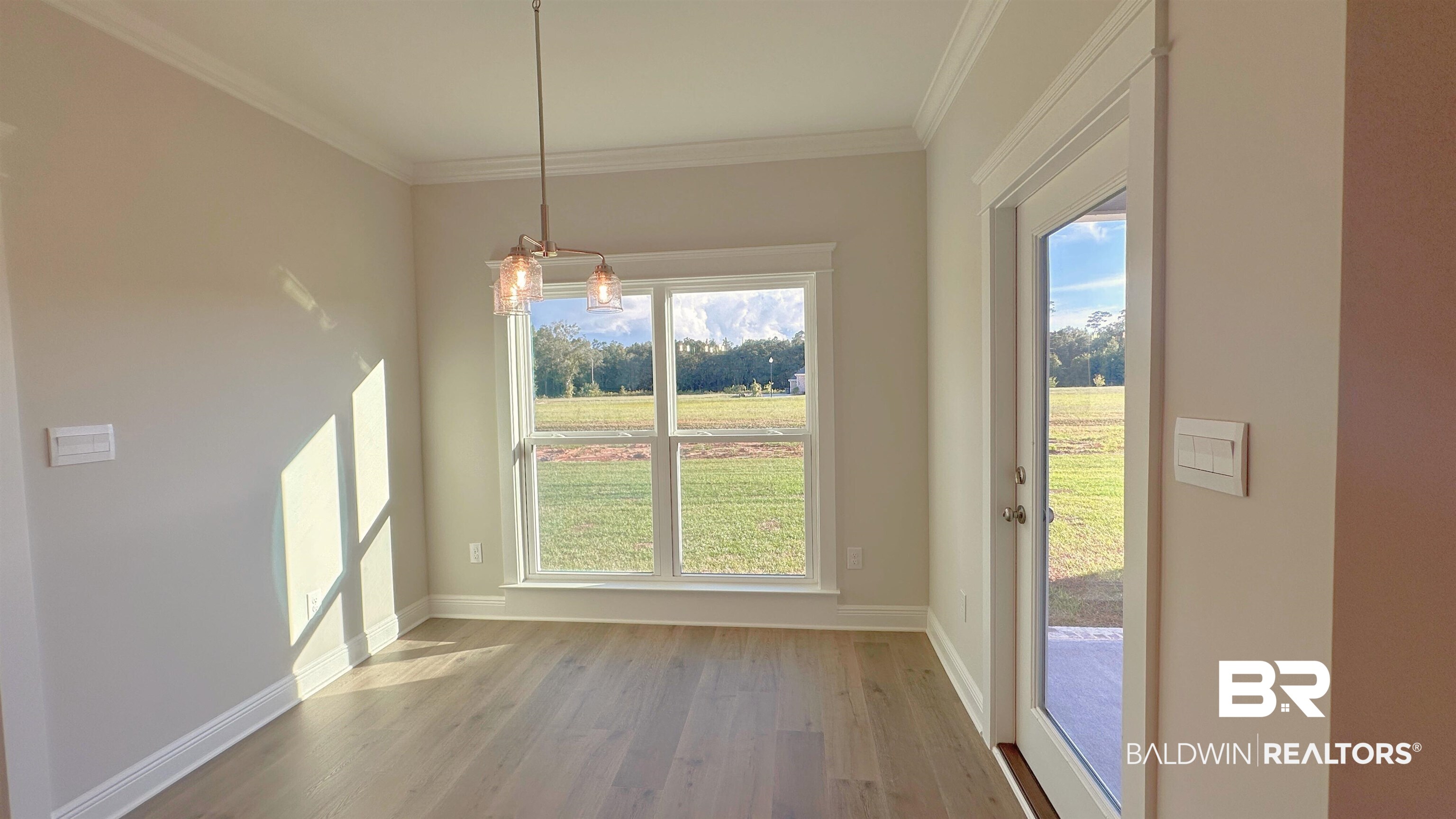 126 Daybreak Trail Fairhope, AL 36532 - Photo 11 of 34 Unfurnished dining area with light wood-style flooring and ornamental molding