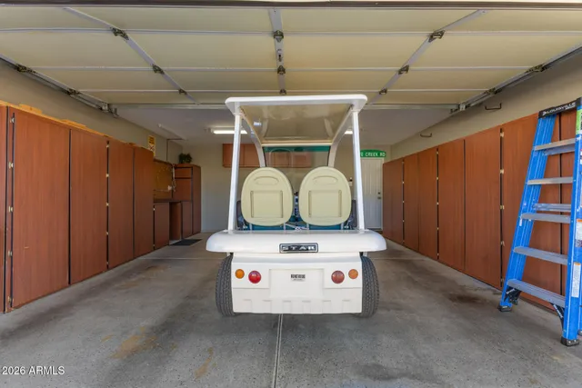 a view of kitchen with stainless steel appliances granite countertop lots of clutter