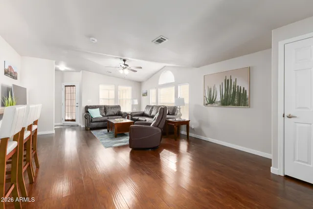 a living room with furniture and wooden floor