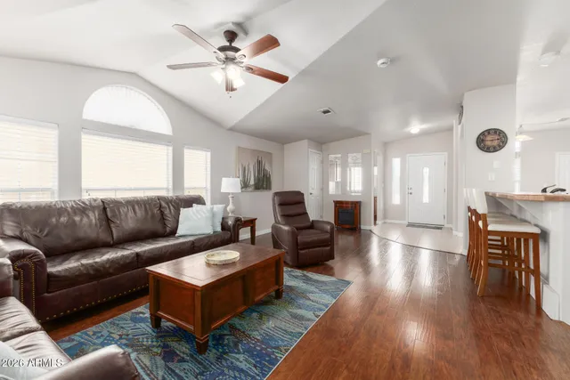 a living room with furniture and wooden floor