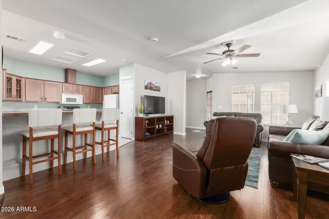 a living room with furniture and kitchen view