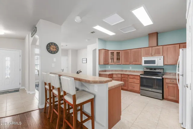 a kitchen with stainless steel appliances granite countertop a stove refrigerator and a refrigerator