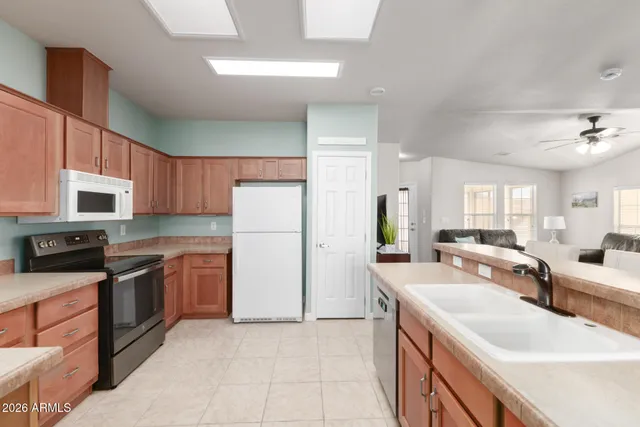 a large kitchen with stainless steel appliances granite countertop a lot of counter space and a sink