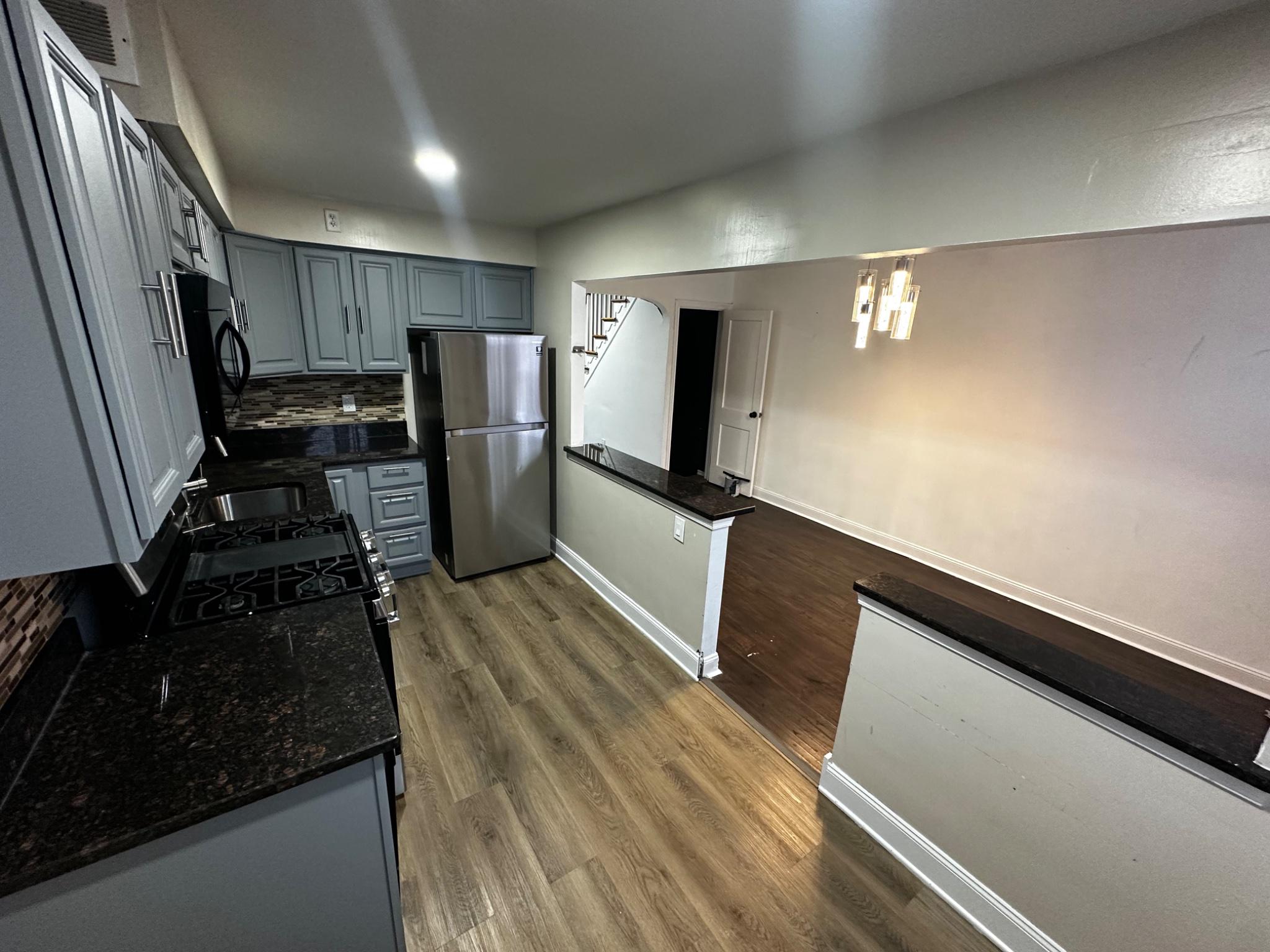 3050 Willits Road Philadelphia, PA 19136 - Photo 6 of 22 a view of a kitchen with refrigerator and wooden floor