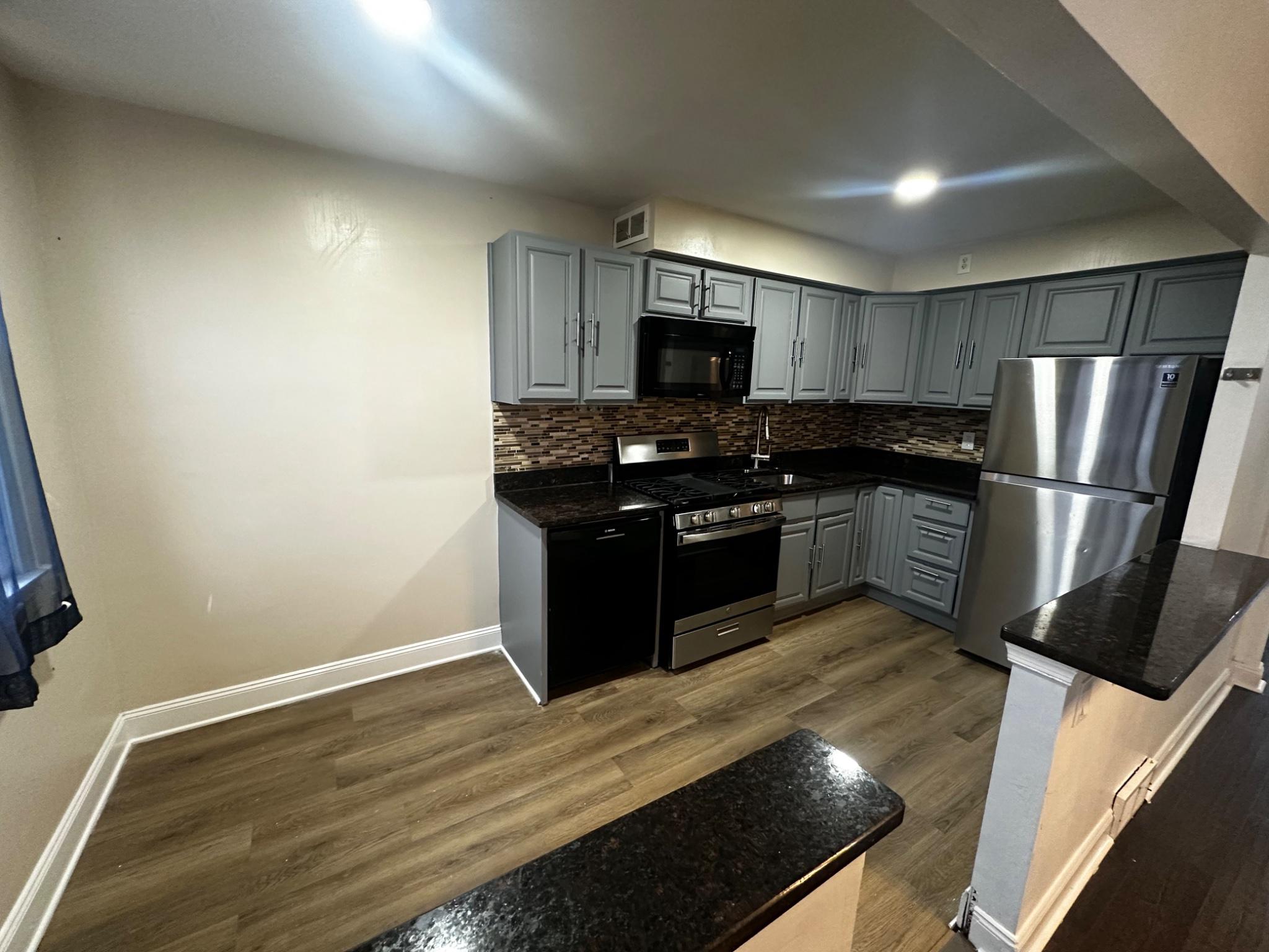 3050 Willits Road Philadelphia, PA 19136 - Photo 7 of 22 a kitchen with stainless steel appliances granite countertop a stove a sink and a refrigerator
