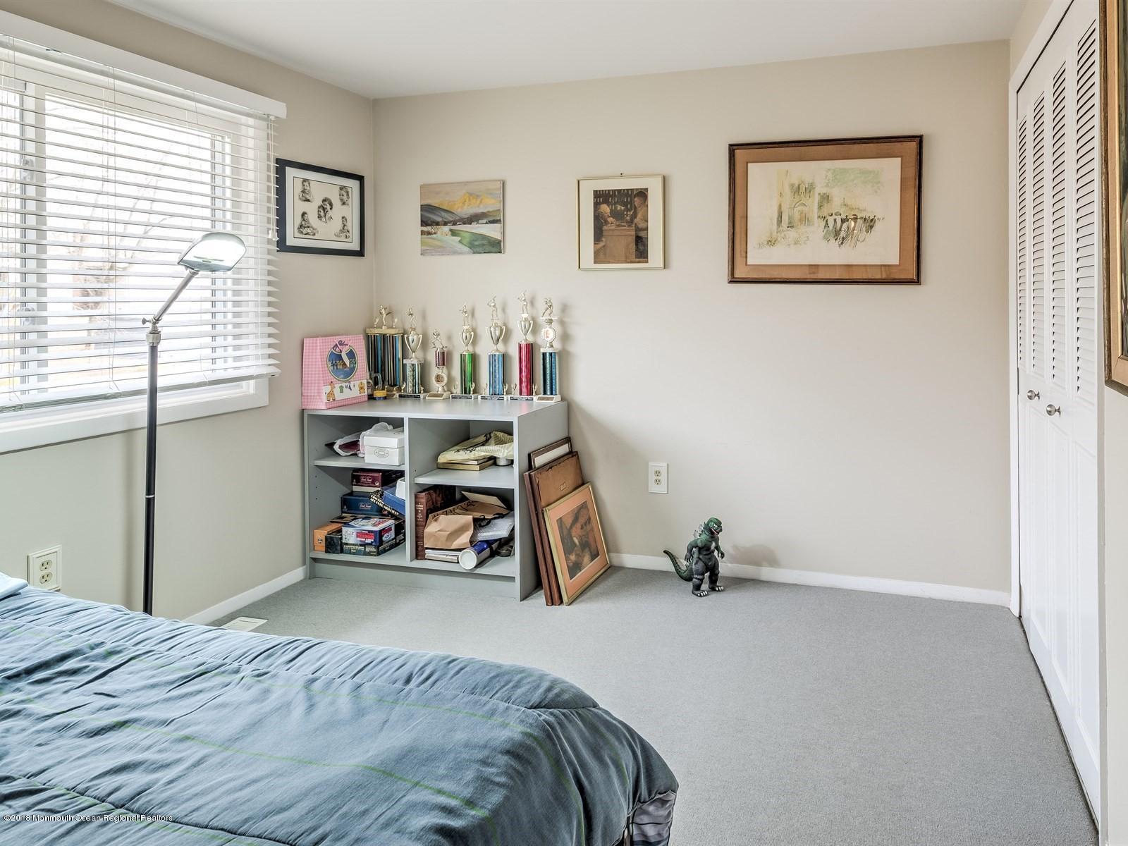 24 Valley Road Manalapan, NJ 07726 - Photo 24 of 30 a view of a bedroom with workspace and a window