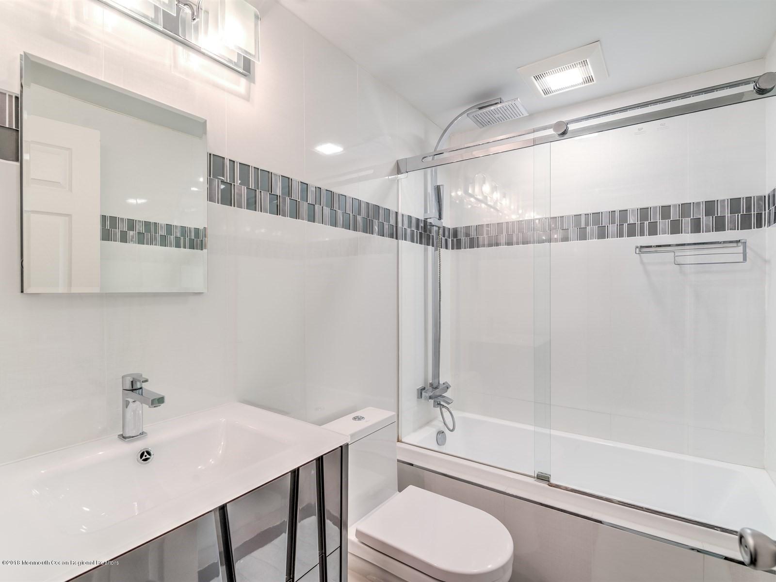 24 Valley Road Manalapan, NJ 07726 - Photo 25 of 30 a bathroom with a sink a toilet and shower