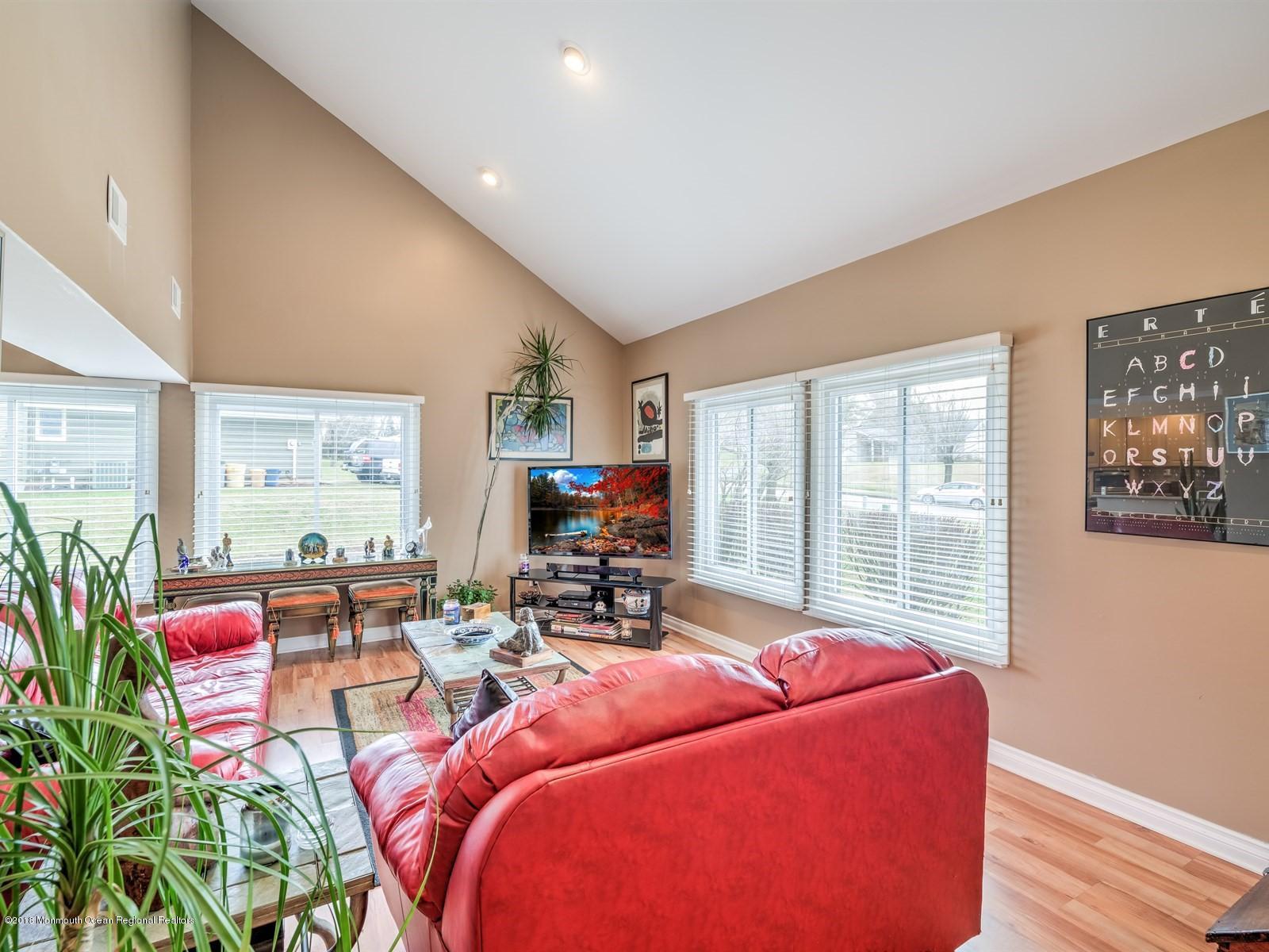 24 Valley Road Manalapan, NJ 07726 - Photo 7 of 30 a living room with furniture and a large window