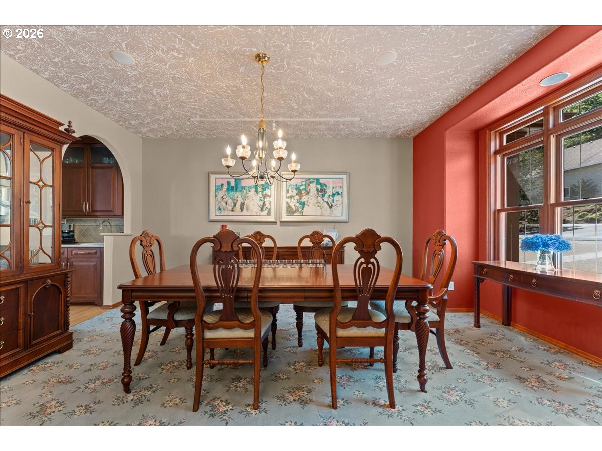 37123 Northeast Reed Road Corbett, OR 97019 - Photo 4 of 48 a view of dining room and livingroom with furniture a chandelier and wooden floor