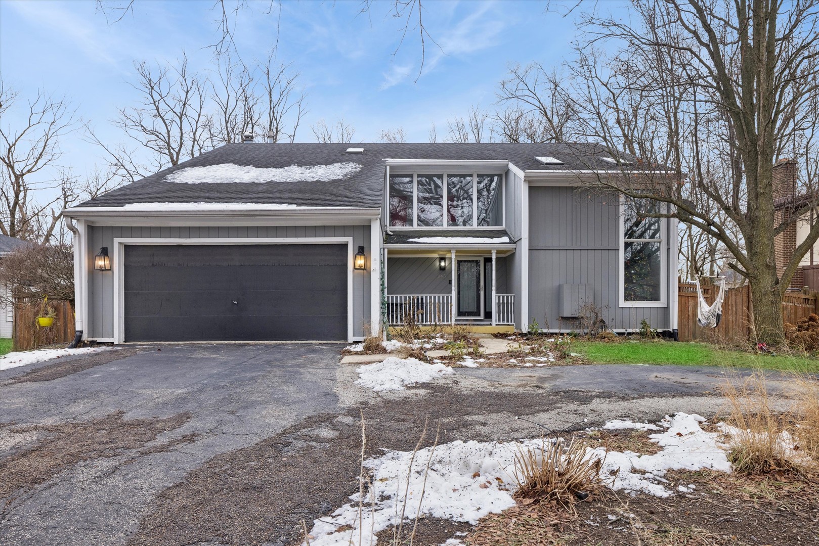 a front view of a house with a yard and a garage