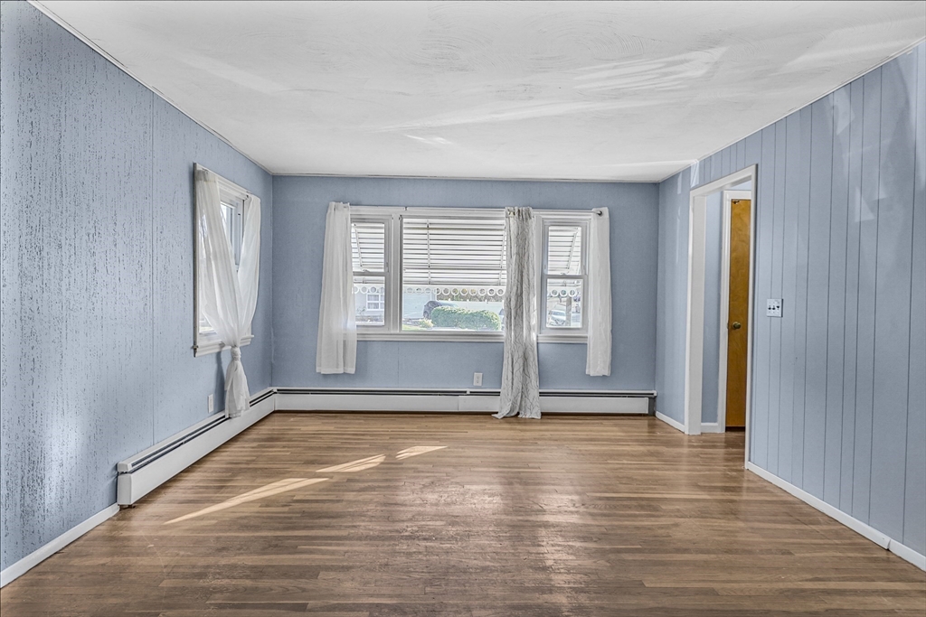 74 Valley Road Springfield, MA 01119 - Photo 12 of 23 an empty room with wooden floor and windows