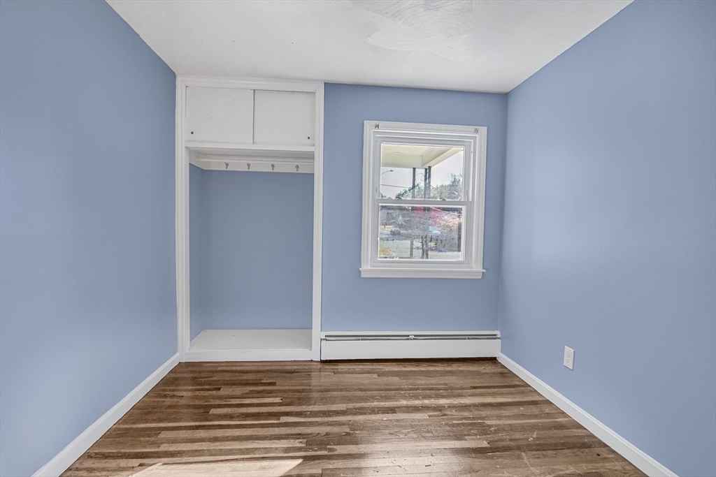 74 Valley Road Springfield, MA 01119 - Photo 16 of 23 a view of an empty room with wooden floor and a window