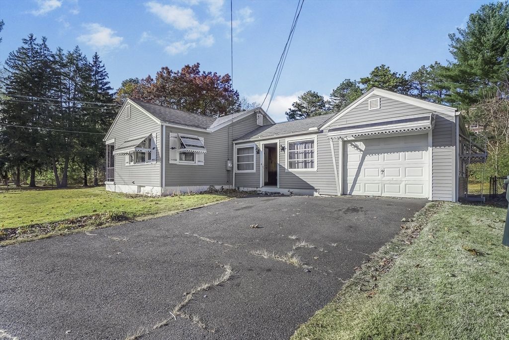 74 Valley Road Springfield, MA 01119 - Photo 2 of 23 a front view of a house with a yard and garage