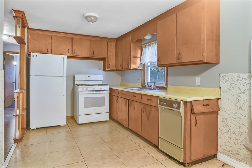 74 Valley Road Springfield, MA 01119 - Photo 9 of 23 a kitchen with stainless steel appliances granite countertop a stove a refrigerator and a sink