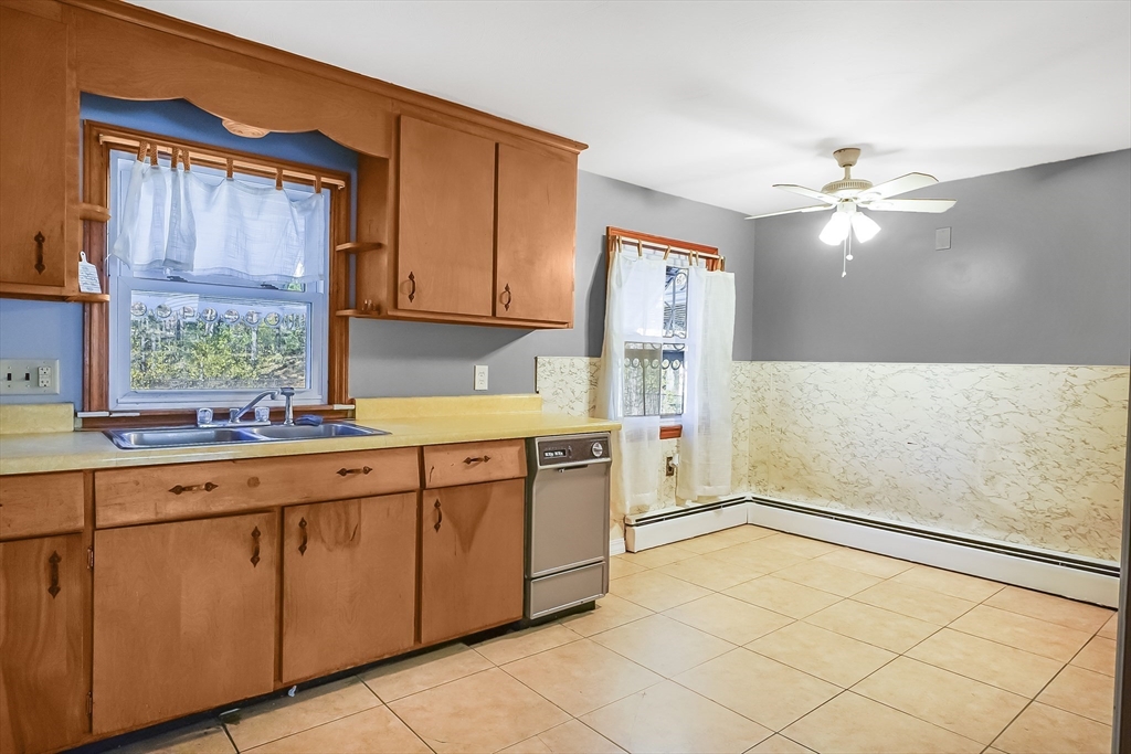 74 Valley Road Springfield, MA 01119 - Photo 10 of 23 a kitchen with cabinets a window and appliances