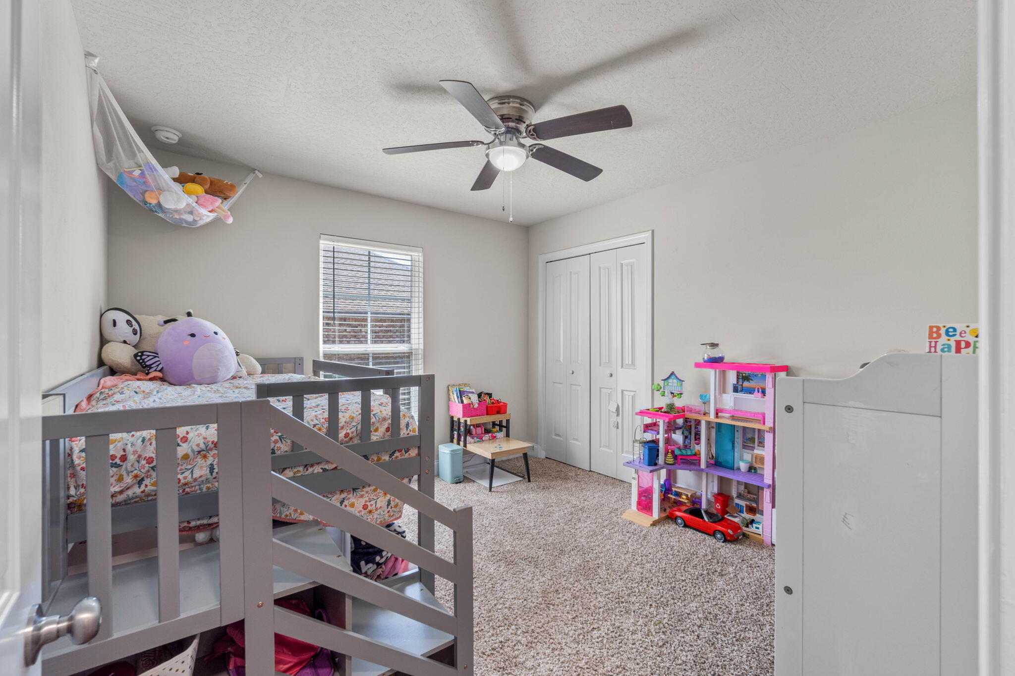 4746 Chanson Crossing Crestview, FL 32539 - Photo 13 of 21 a bedroom with furniture a baby crib and a window
