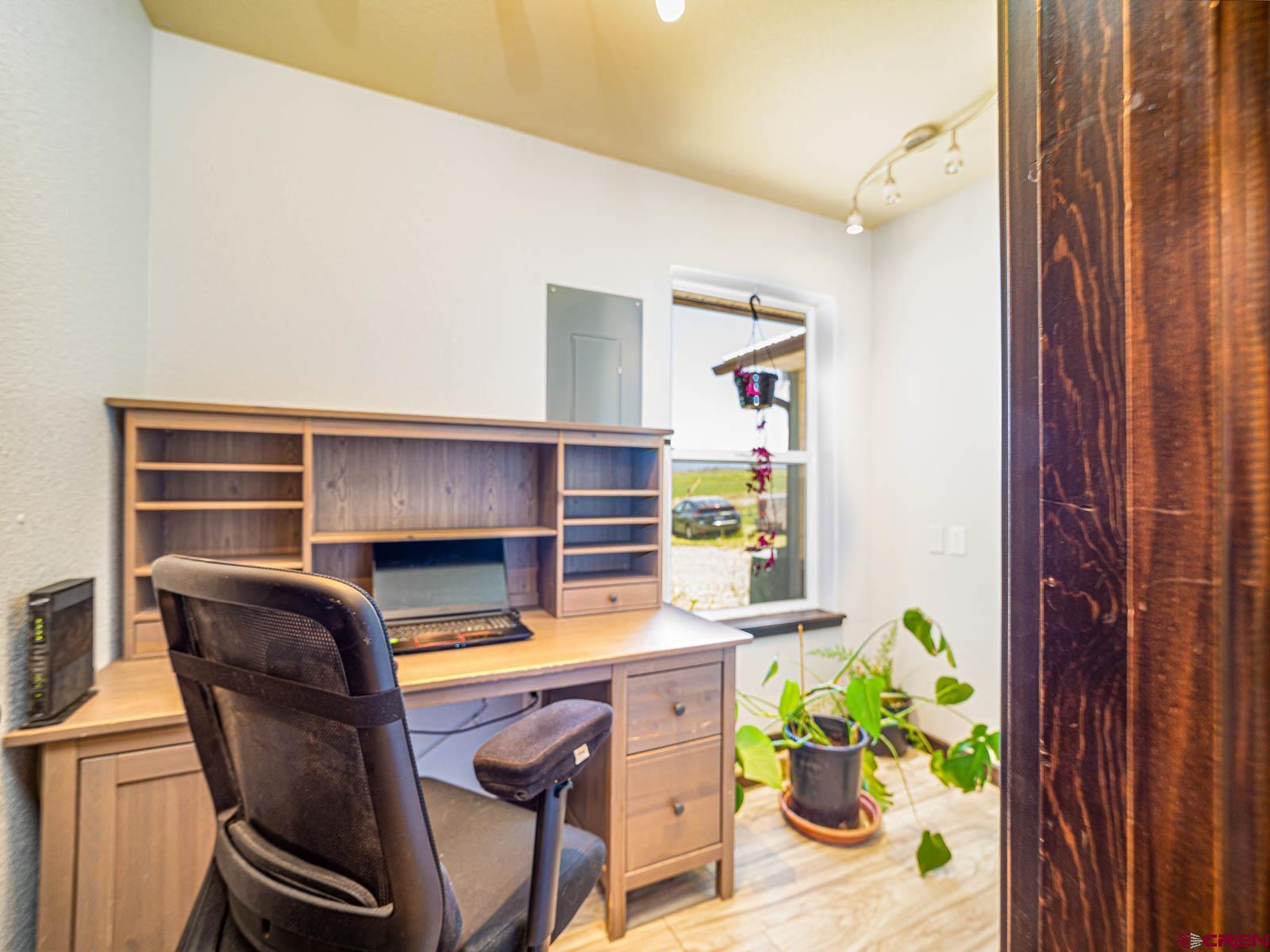 5085 3675th Road Crawford, CO 81415 - Photo 14 of 35 a workspace with furniture and a potted plant