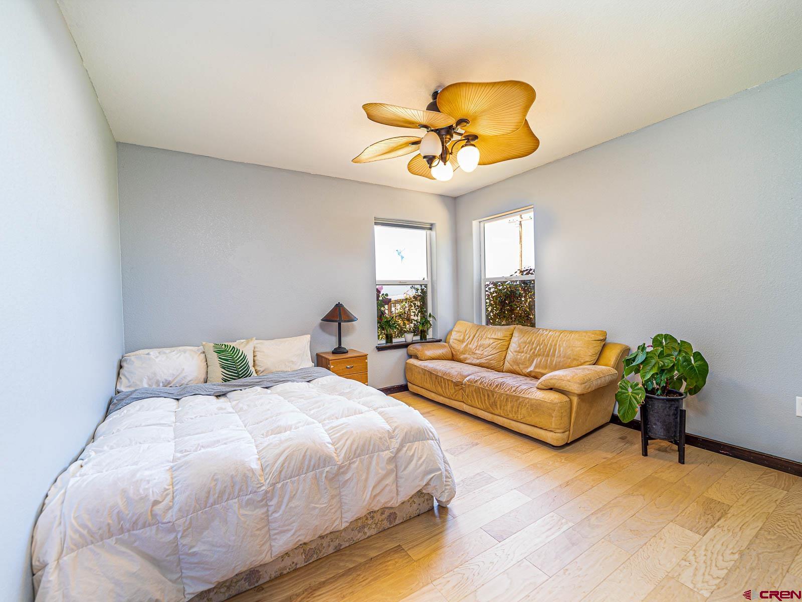 5085 3675th Road Crawford, CO 81415 - Photo 16 of 35 a bedroom with a bed and a chandelier