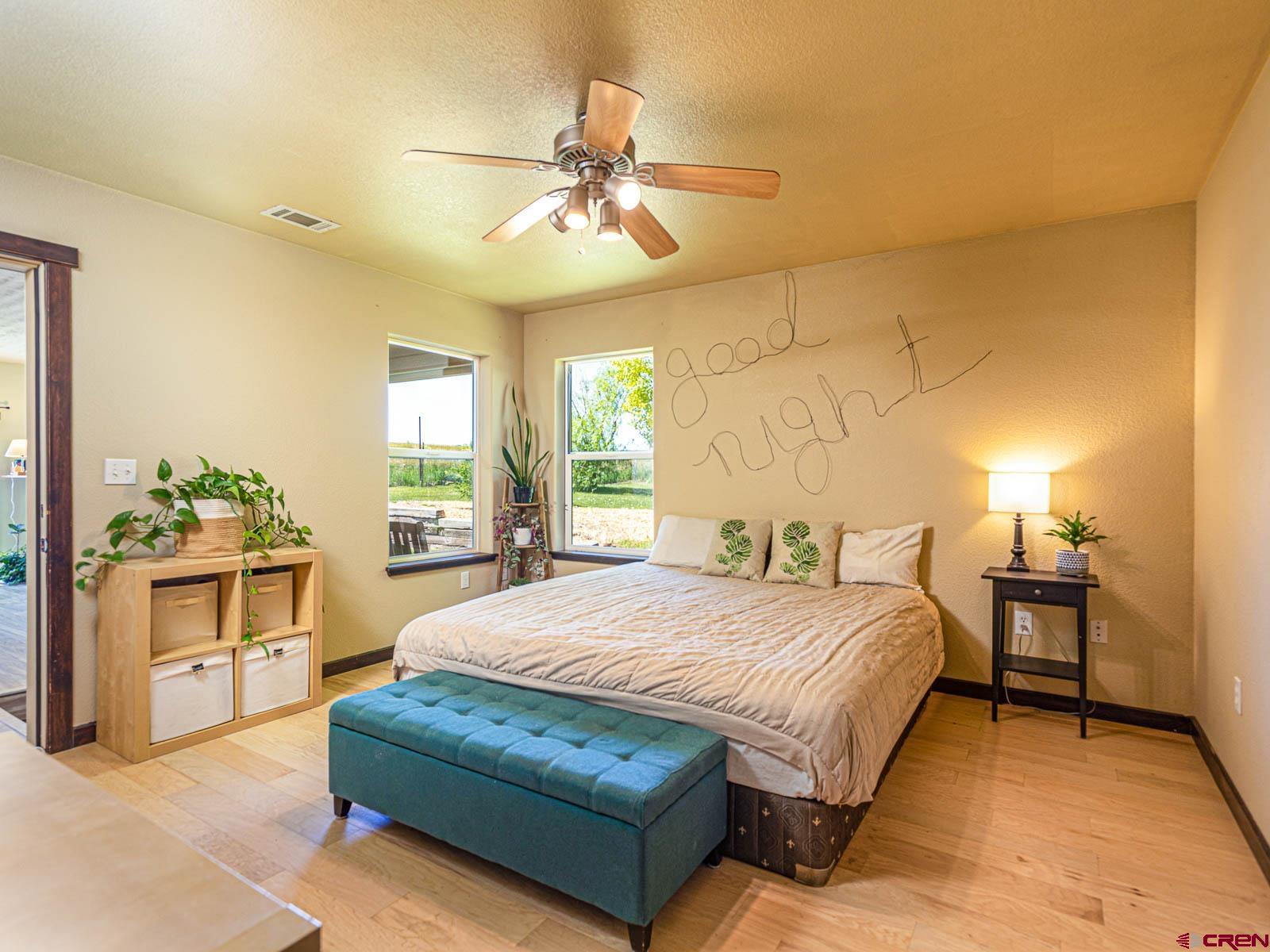 5085 3675th Road Crawford, CO 81415 - Photo 18 of 35 a bedroom with a large bed and a chandelier