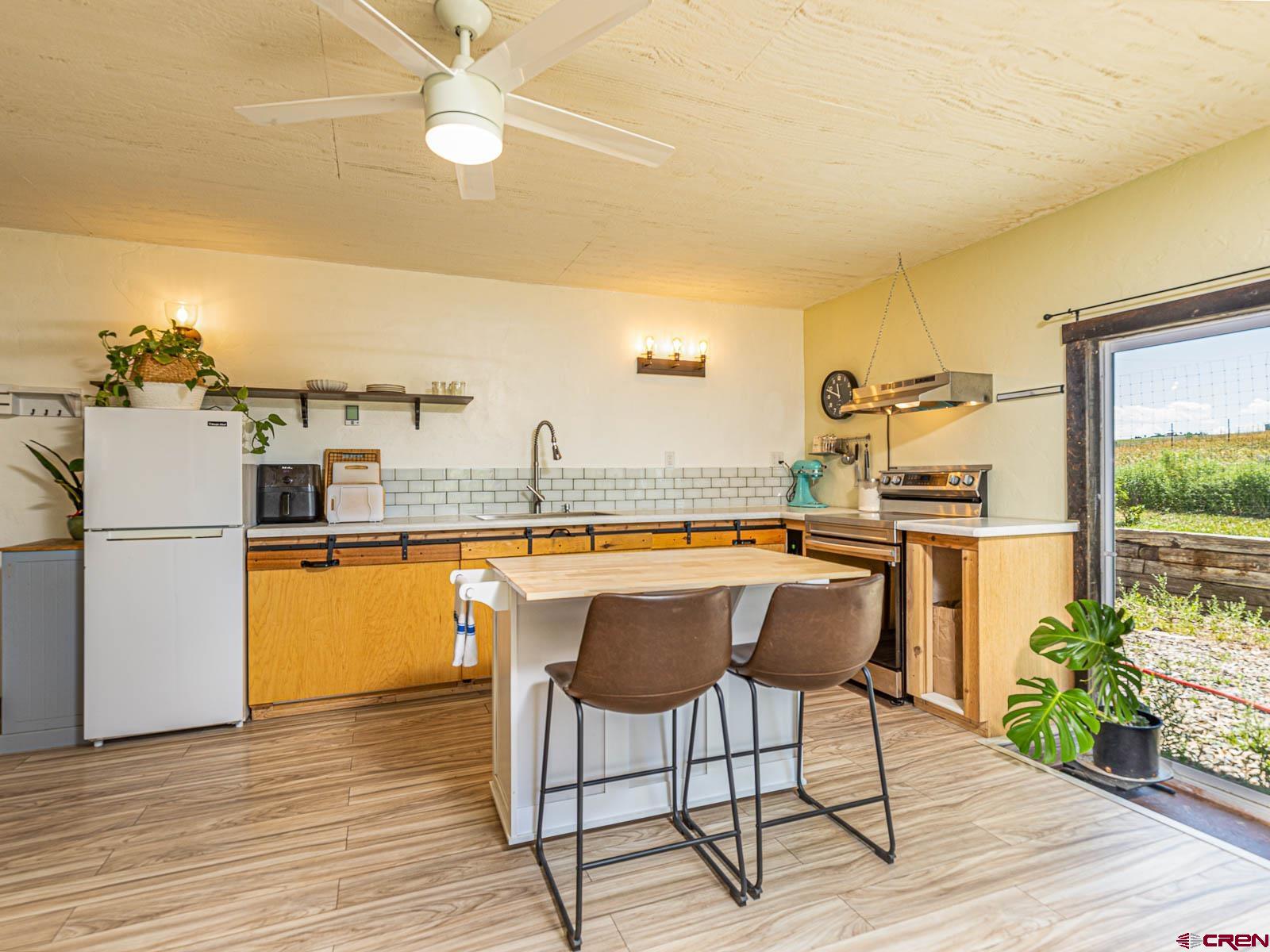 5085 3675th Road Crawford, CO 81415 - Photo 20 of 35 a kitchen with a sink cabinets and wooden floor