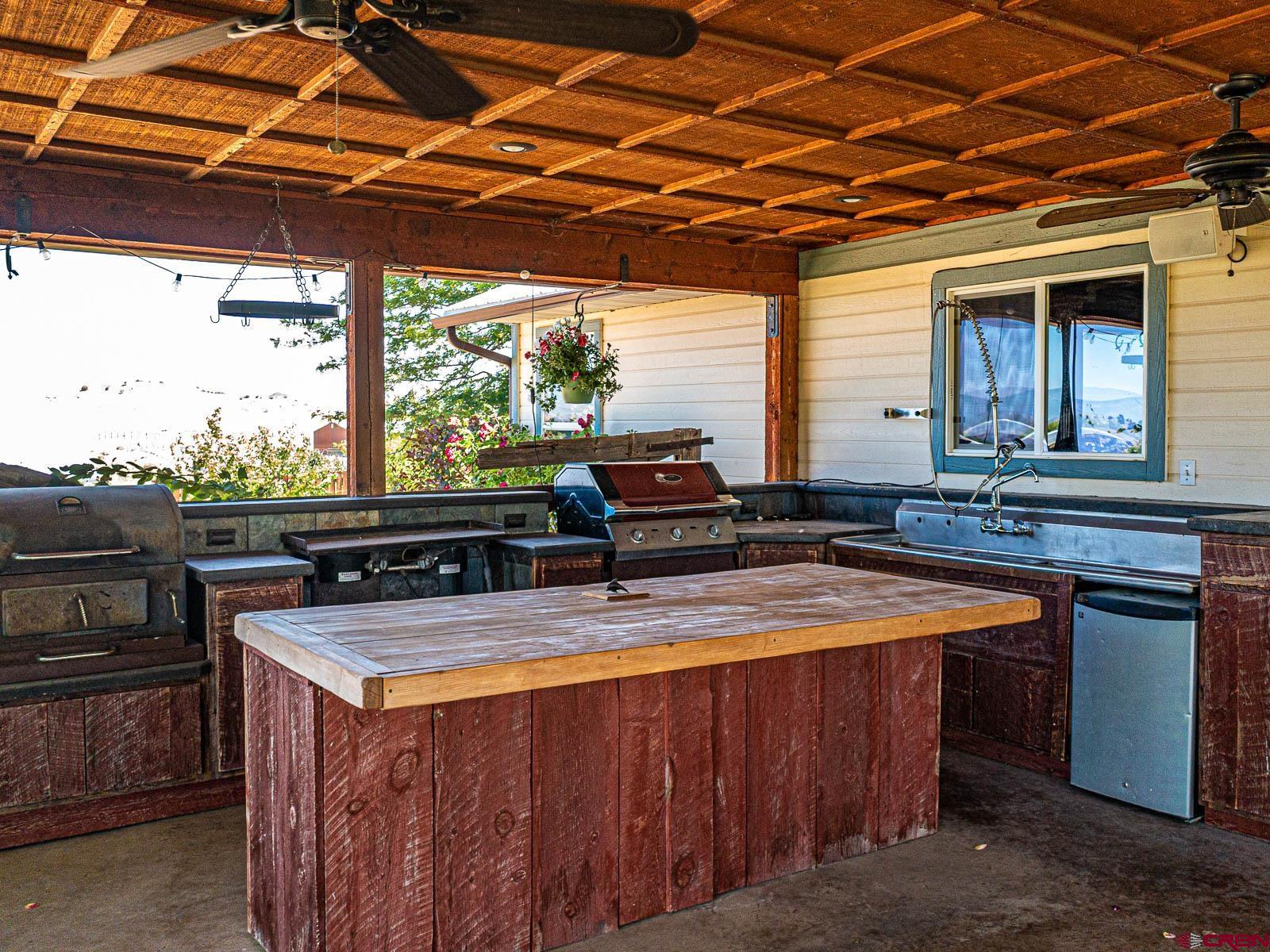5085 3675th Road Crawford, CO 81415 - Photo 22 of 35 a view of a outdoor kitchen with a sink and large window