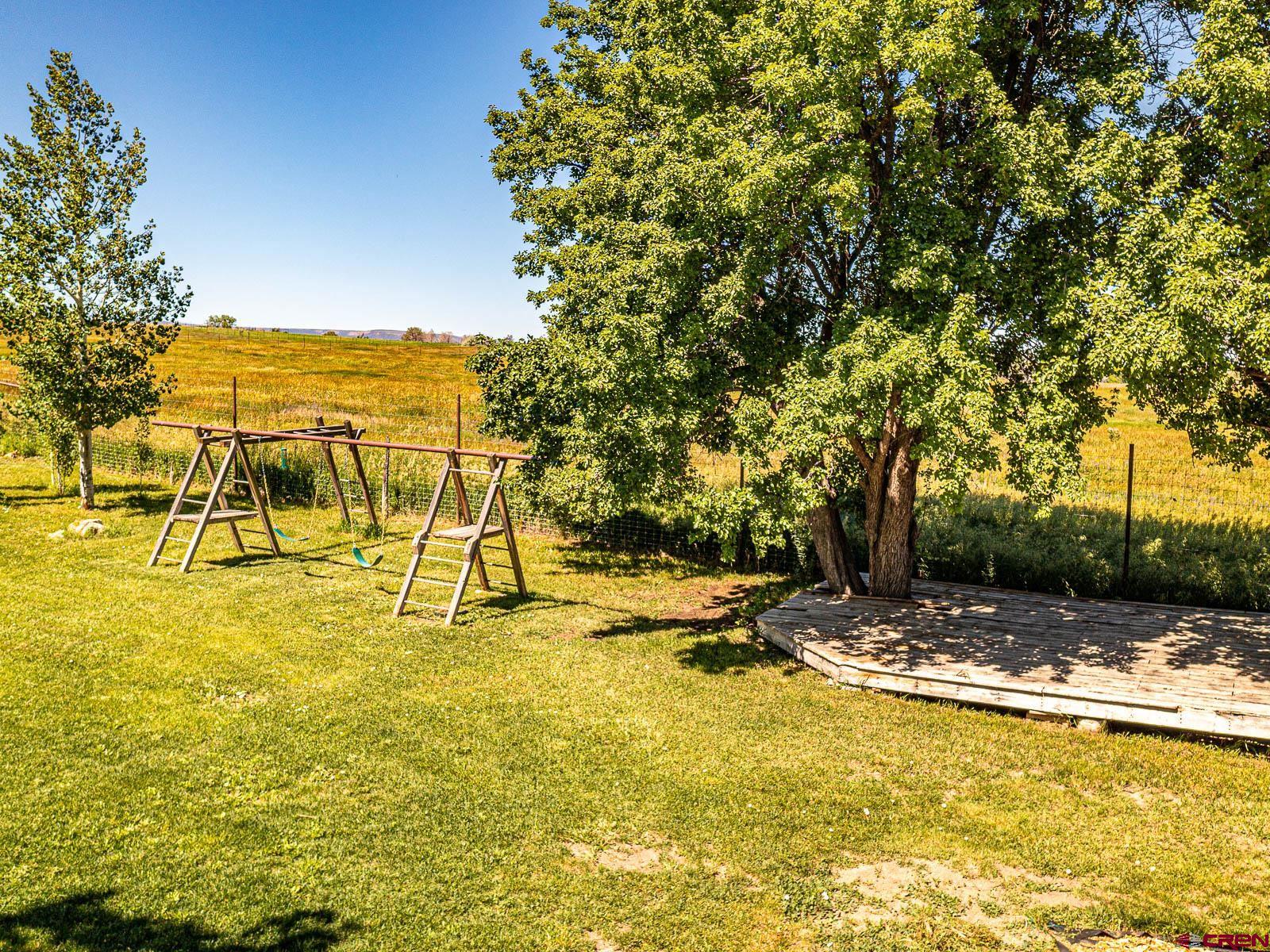 5085 3675th Road Crawford, CO 81415 - Photo 26 of 35 a view of a swimming pool with an outdoor seating and a yard