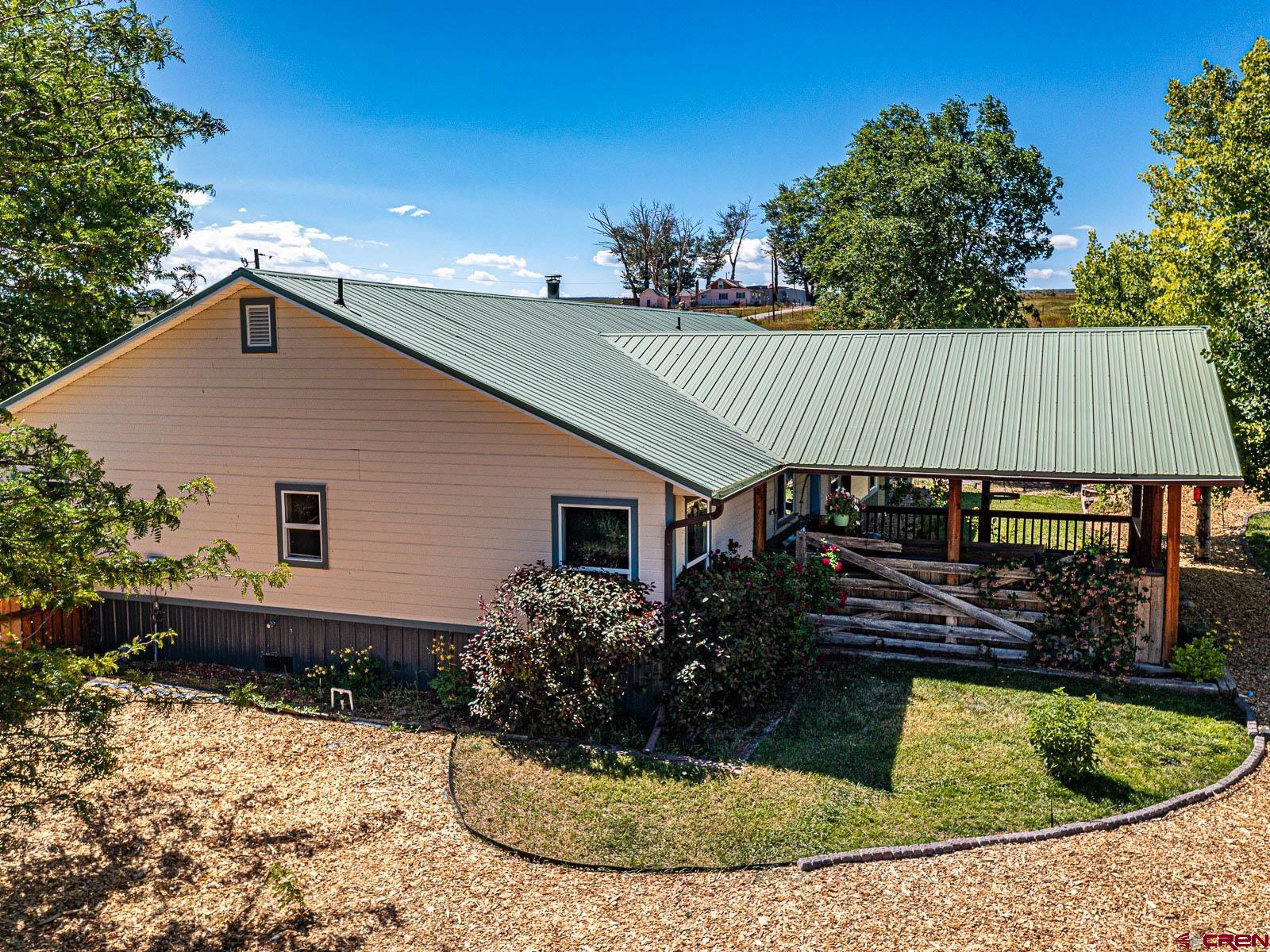 5085 3675th Road Crawford, CO 81415 - Photo 27 of 35 a view of a house with a yard plants and wooden fence