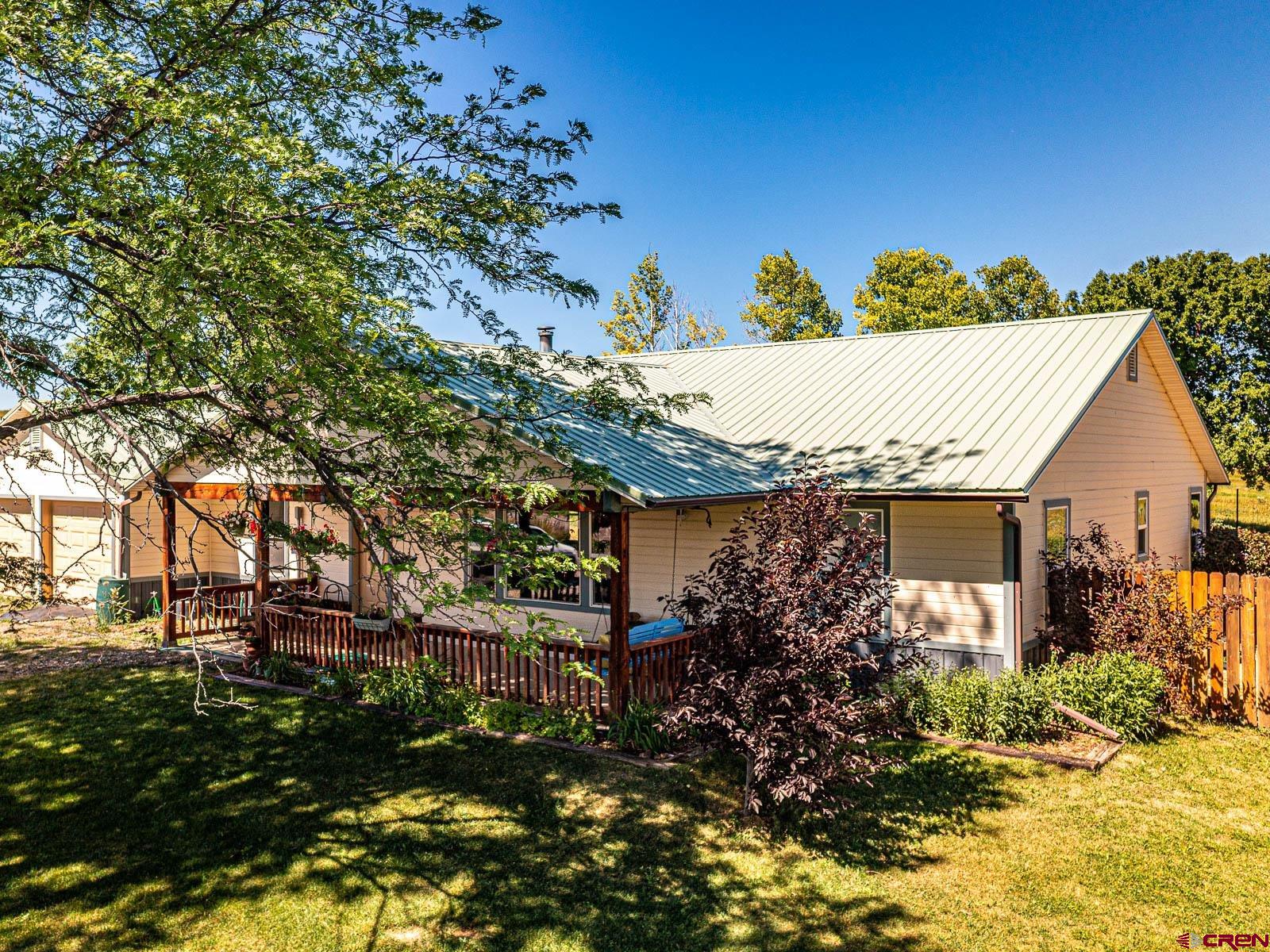 5085 3675th Road Crawford, CO 81415 - Photo 4 of 35 a view of a house with a tree in the background