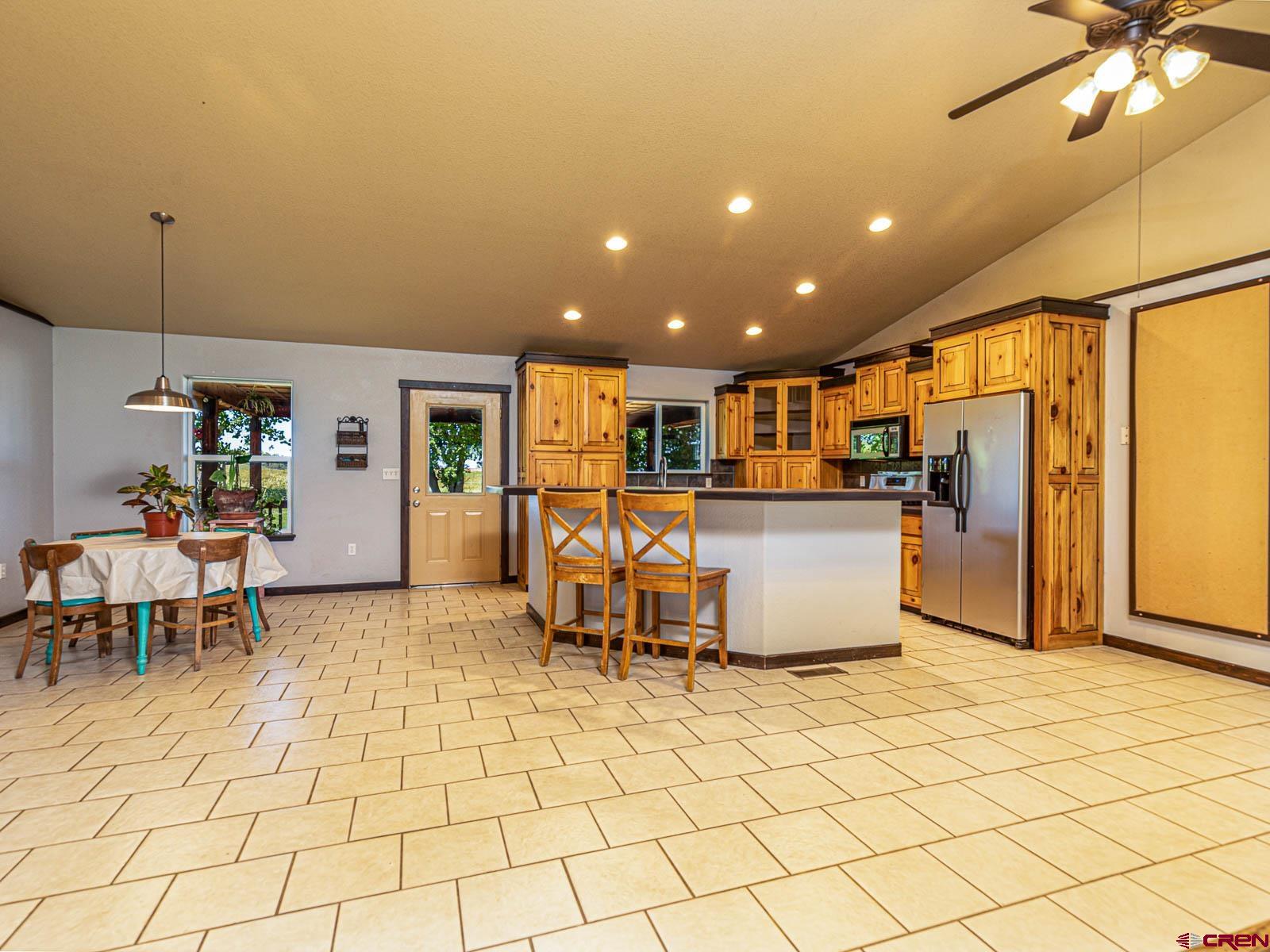 5085 3675th Road Crawford, CO 81415 - Photo 8 of 35 a kitchen with stainless steel appliances kitchen island granite countertop dining table chair and a sink